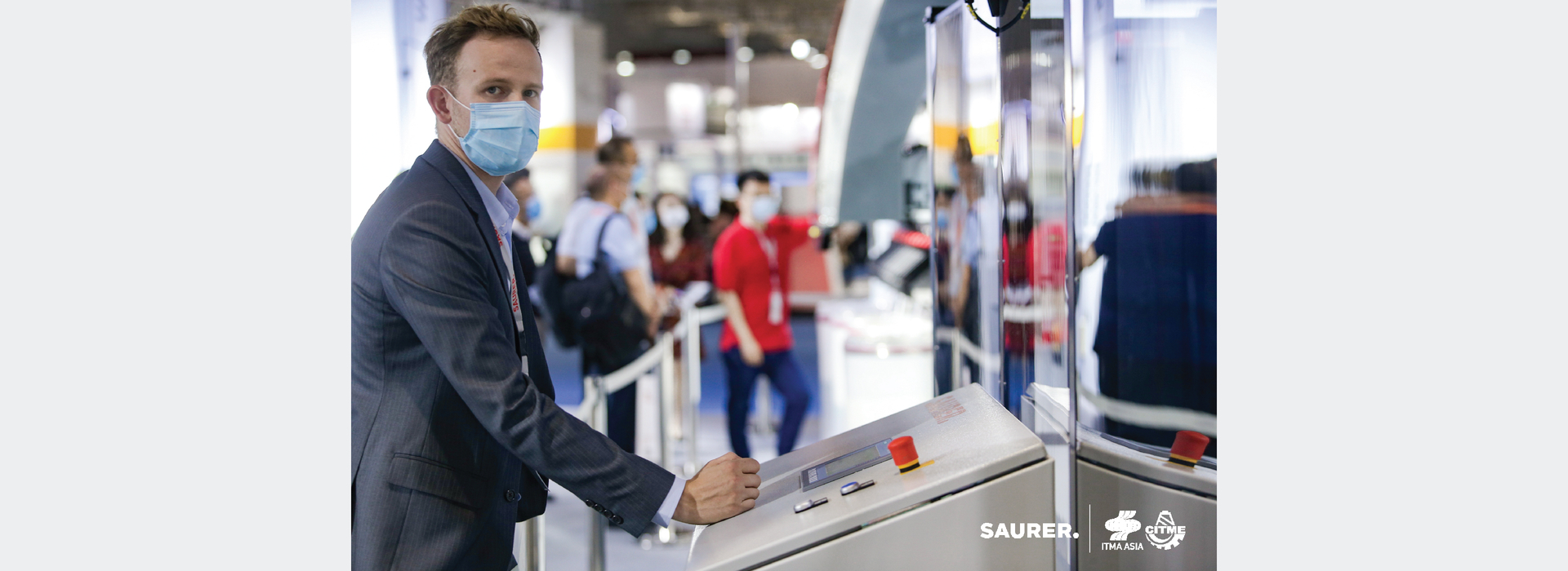 Saurer ITMA Asia employee at console