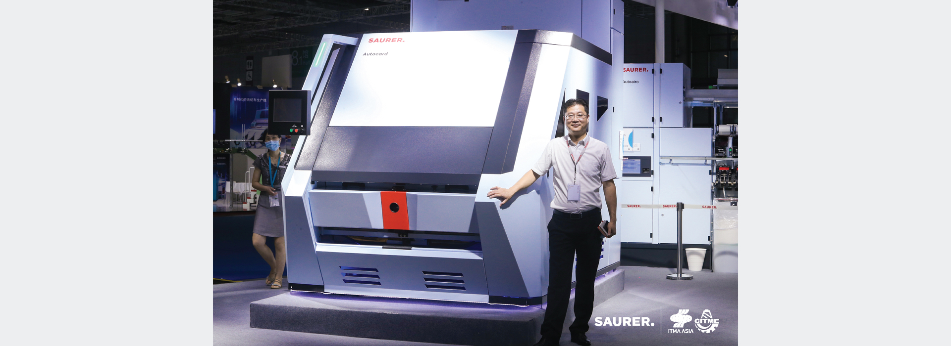 Saurer ITMA Asia employee with Autocard
