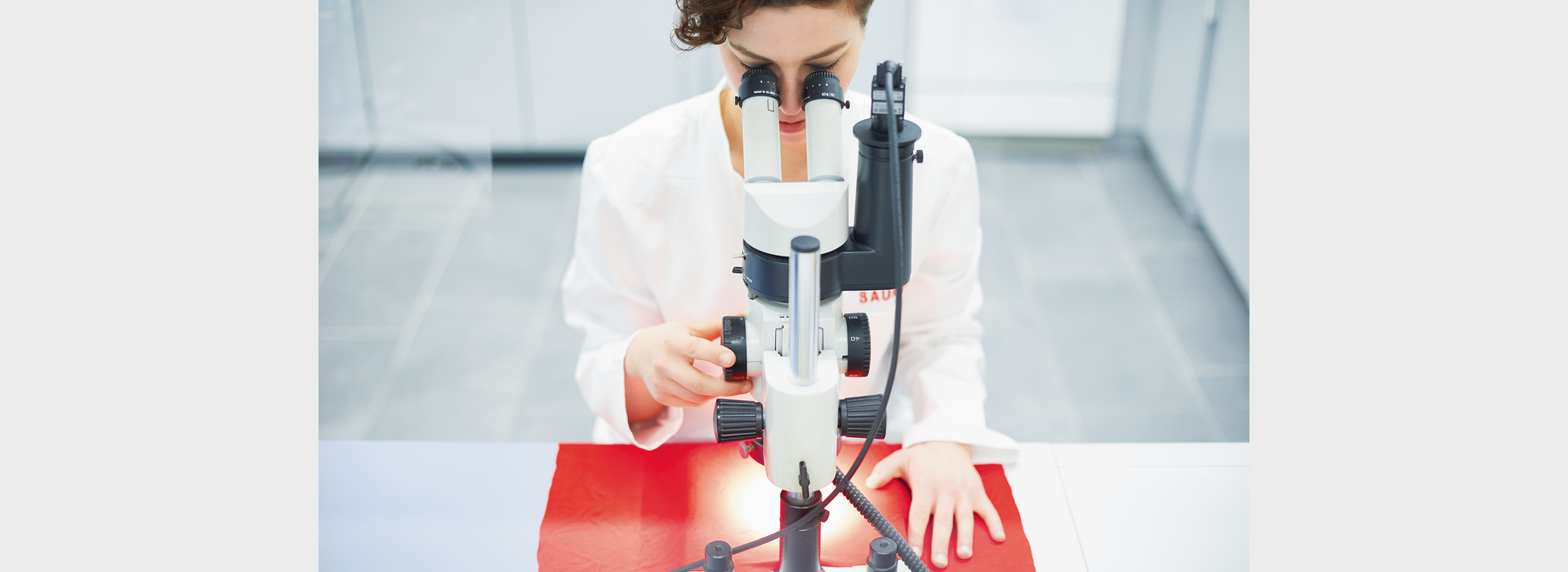 Saurer Laboratory Eileen Wilhelm at microscope