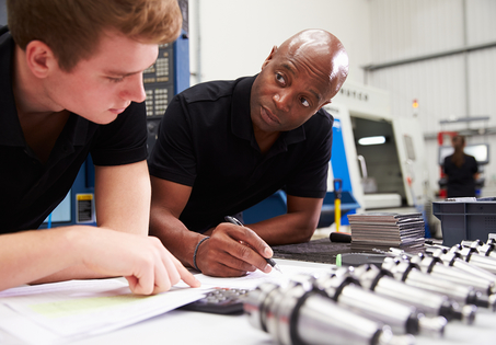 Two men in laboratory with components