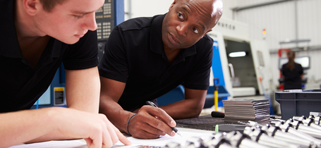 Two men in laboratory with components